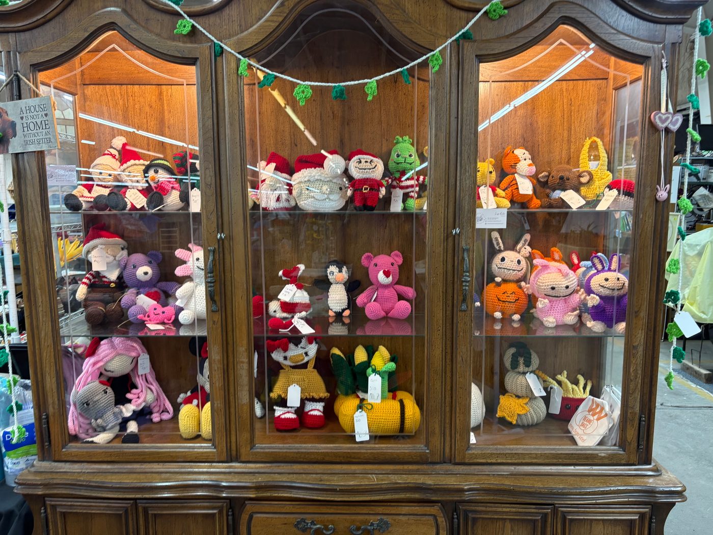 A cabinet of finished pieces, from toys to seasonal decor